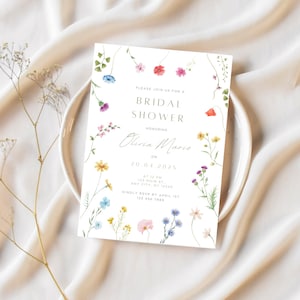 May include: A white bridal shower invitation with a floral border. The invitation reads "Please join us for a bridal shower honoring Olivia Marie on 20.04.2025 at 12 pm, 123 Main St, Any City, NY 12345. Kindly RSVP by April 1st, 123 456 7899."