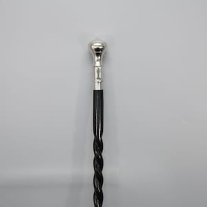 elegant walking stick, twisted cane, wood and metal, black and silver