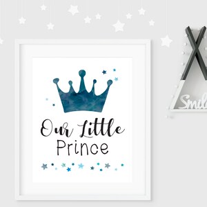 K&ouml;nnte beinhalten: Ein wei&szlig;er gerahmter Druck mit einer blauen Aquarellkrone und dem Text "Our Little Prince" umgeben von blauen und wei&szlig;en Sternen.