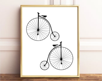 May include: Black and white line art print of two vintage bicycles with large front wheels and small back wheels.