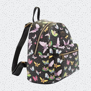 May include: Black backpack with a colorful butterfly pattern. The backpack has a small front pocket with a zipper.