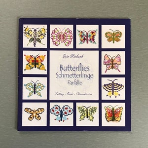 May include: A square book cover with a dark blue border features multiple butterfly illustrations in various colors. The center of the cover displays the title "Butterflies" in English, German, and Italian, with the author's name above.