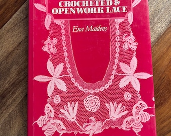 May include: A red book titled "The Techniques of Crocheted & Openwork Lace" by Ena Maidens. The cover features a white crocheted lace design.