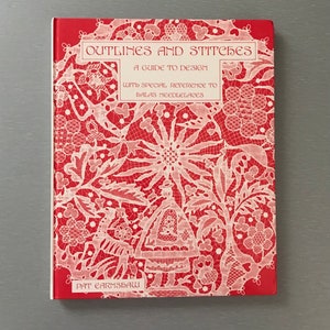 May include: A hardcover book titled Outlines and Stitches: A Guide to Design with Special Reference to Halas Needlelaces by Pat Earnshaw. The cover is bright red with a white, intricate lace-like pattern featuring floral and figure motifs.