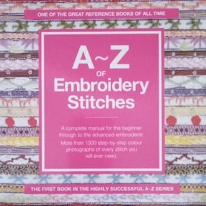 May include: A pink book titled "A~Z of Embroidery Stitches" with a colorful embroidered border. The book cover states "One of the great reference books of all time" and "The first book in the highly successful A-Z series".