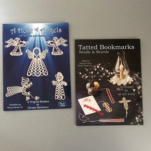 May include: Two books with white covers and colourful images. The book on the left is titled "A Host of Angels" and features a white angel design. The book on the right is titled "Tatted Bookmarks" and features a variety of colourful bookmarks.