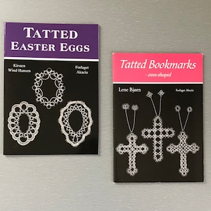 May include: Two books with black covers and white text. The book on the left is titled "Tatted Easter Eggs" and features three tatted lace designs. The book on the right is titled "Tatted Bookmarks - cross-shaped" and features three tatted lace cross designs.