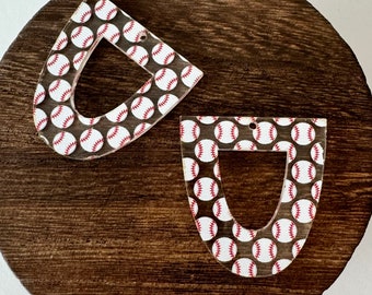 May include: Two clear acrylic earrings shaped like a baseball catcher's mitt with a white and red baseball pattern.