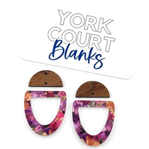 May include: Two earring components featuring a dark wood semi-circle top piece and a floral patterned bottom piece in shades of pink, purple, and orange. A white display card with the text YORK COURT Blanks is positioned above the components.