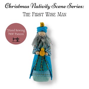 May include: A hand-sewn felt ornament of the first wise man from a nativity scene. He is wearing a blue robe with gold trim and a blue hat with a gold star. He is holding a gold star in his hand. The ornament is part of a series of nativity scene ornaments.