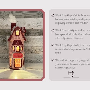 May include: A felt craft kit for a light-up bakery building. The kit includes a cardboard base, embroidered felt pieces, and a wire harness for lighting. The building is decorated with a red roof, white trim, and a sign that reads "BAKERY".
