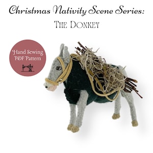 May include: A hand-sewn felt donkey with a green blanket and a bundle of twigs on its back. The donkey is a Christmas nativity scene ornament. The image includes the text "Hand Sewing PDF Pattern".