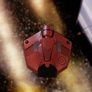 Puede incluir: Un dron rojo y negro con un botón de encendido y una superficie texturizada. El dron tiene un diseño futurista y está flotando en el aire.