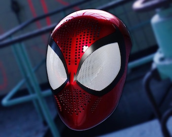 May include: A red and black Spider-Man mask with a mesh eye design. The mask is made of a hard plastic material and has a glossy finish.