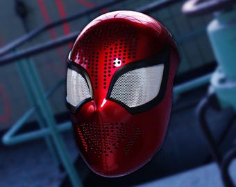 May include: A red and black Spider-Man mask with a mesh eye covering. The mask has a textured surface with small holes.