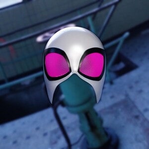 May include: A white superhero mask with black trim and bright pink mesh eye coverings. The mask is designed with a smooth, rounded shape and a distinctive facial opening.