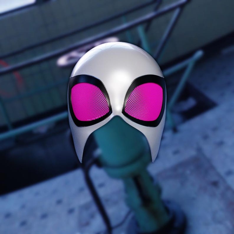 May include: A white superhero mask with black trim and bright pink mesh eye coverings. The mask is designed with a smooth, rounded shape and a distinctive facial opening.