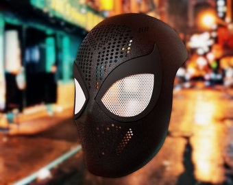 May include: Black and white Spider-Man mask with a mesh design. The mask has a black background with white mesh eyes and a black spider design.