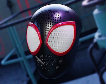 May include: A black and red Spider-Man mask with a mesh eye design. The mask has a textured surface with small holes.