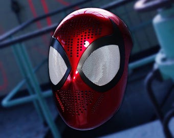 May include: A red and black Spider-Man mask with a mesh eye covering. The mask has a textured surface with small holes.