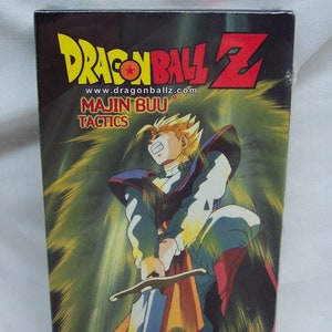 May include: A VHS tape cover for Dragon Ball Z: Majin Buu Tactics. The cover features a yellow and orange background with a character holding a sword. The text on the cover reads "Dragon Ball Z" and "Majin Buu Tactics".