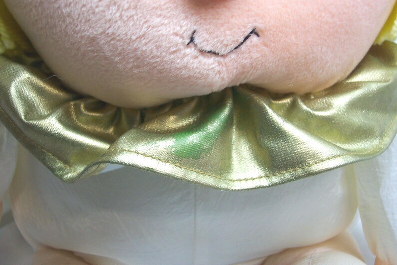 May include: A set of three ceramic mugs with a speckled, matte finish. The mugs are in shades of cream, light gray, and dark gray. Each mug has a simple, minimalist design and a rounded handle.