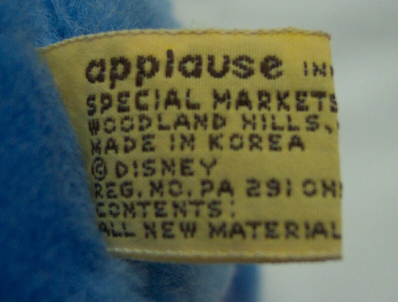 May include: Yellow tag with brown text that reads "applause IND SPECIAL MARKETS WOODLAND HILLS MADE IN KOREA &copy;DISNEY REG. NO. PA 2910N CONTENTS: ALL NEW MATERIAL"