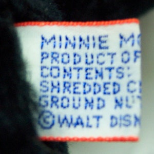 May include: White tag with red trim, reading "Minnie Mouse Product of Contents: Shredded Cloth Ground Nut &copy; WALT DISNEY"