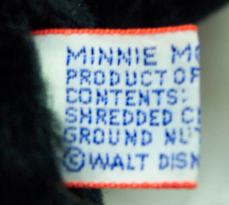 May include: White tag with red trim, reading "Minnie Mouse Product of Contents: Shredded Cloth Ground Nut &copy; WALT DISNEY"