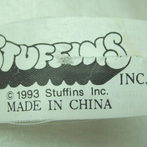 May include: A white fabric tag with the word "STUFFINS" in a black, bubble-style font. Below the logo are the words "INC." and "&copy; 1993 Stuffins Inc. MADE IN CHINA."