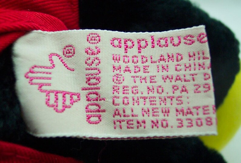 May include: A white tag with pink lettering that reads "applause" and "Woodland Hills, Made in China, The Walt Disney Company, Reg. No. PA 29, Contents: All New Materials, Item No. 3308".