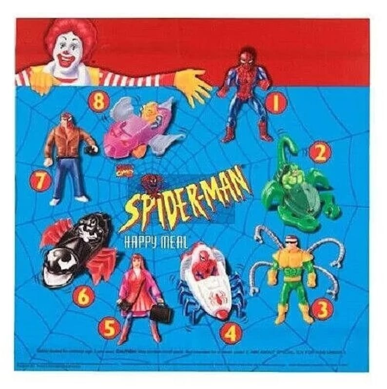 Pu&ograve; includere: Un set di giocattoli Spider-Man Happy Meal con una variet&agrave; di personaggi, tra cui Spider-Man, Venom, Doc Ock e Goblin. I giocattoli sono numerati da 1 a 8 e sono visualizzati su uno sfondo blu con le parole "Spider-Man Happy Meal".