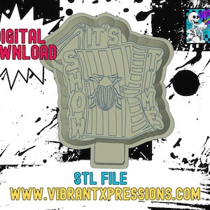 May include: A 3D printed STL file for a "It's Showtime" sign with a beetle design. The sign is a light gray color and has a textured surface.