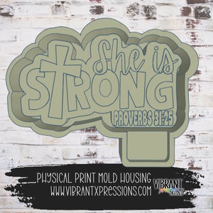 May include: A green 3D printed mold for making cookies or other treats. The mold is shaped like a cloud with the words "She is STRONG" and a cross. The text "Proverbs 31:25" is also included.