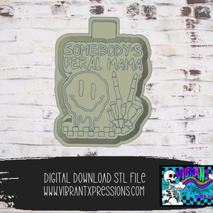 May include: A digital download STL file for a 3D printed cookie cutter. The cutter is shaped like a melting smiley face with a peace sign made of bones. The text "Somebody's Feral Mama" is written above the smiley face.