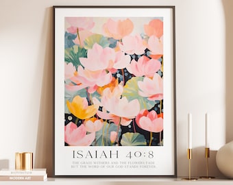 May include: A framed print with a watercolor painting of pink and yellow flowers. The print has the text "ISAIAH 40:8" and the quote "The grass withers and the flowers fade but the word of our God stands forever."