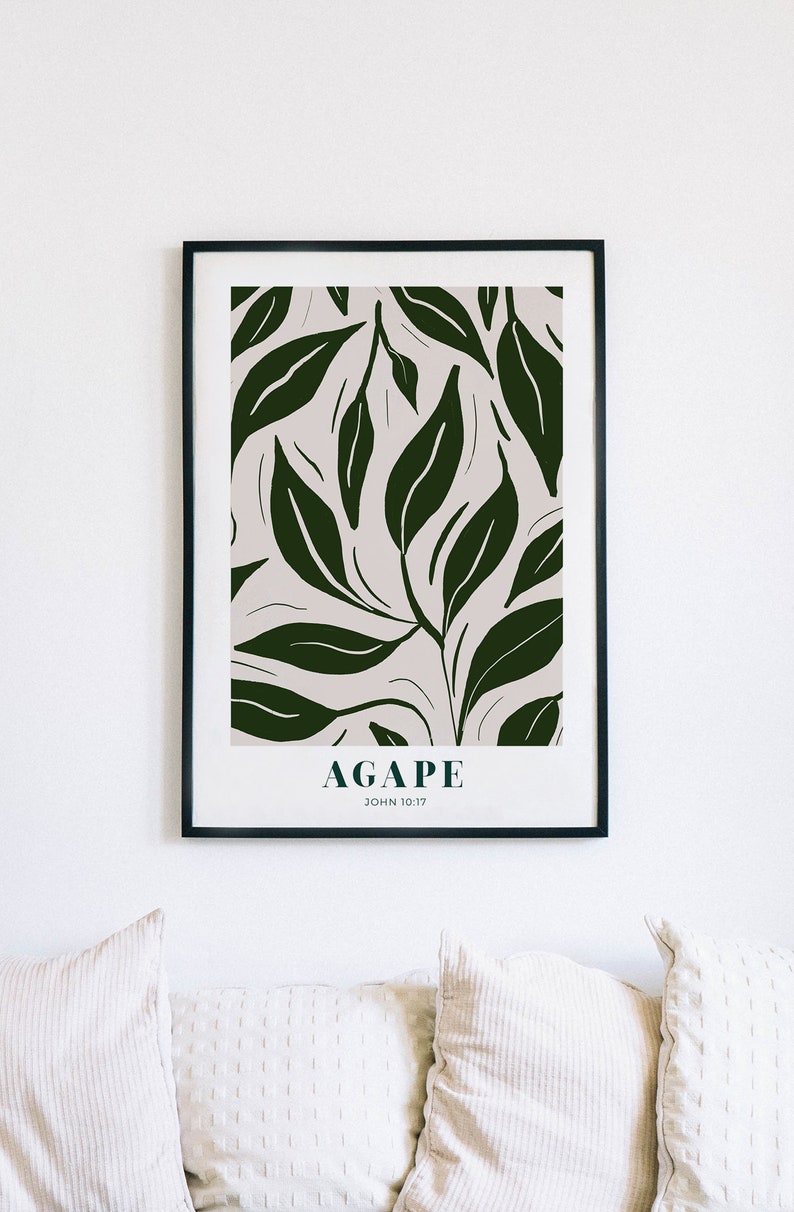 May include: A framed print with a white background and a dark green leafy pattern. The text "AGAPE JOHN 10:17" is printed at the bottom of the print.