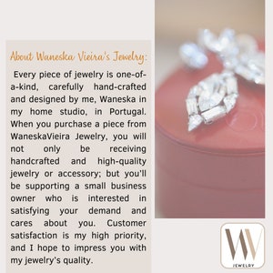 May include: A red jewelry box with a silver and crystal brooch on top. The box has the text "W Jewelry" on the front.