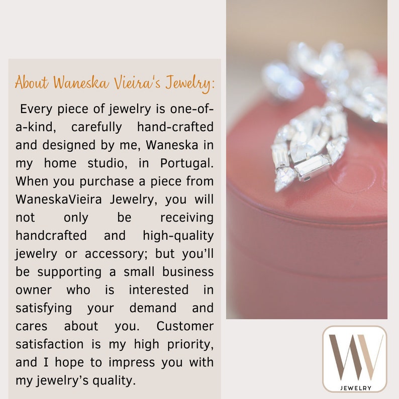 May include: A red jewelry box with a silver and crystal brooch on top. The box has the text "W Jewelry" on the front.