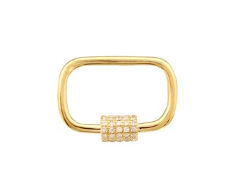 May include: A gold-colored rectangular clasp with a cylindrical center. The center is encrusted with small, clear gemstones. The clasp is designed for jewelry making or as a decorative element.