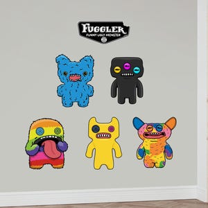 May include: Five colorful wall decals featuring cartoon monsters with the text "Fuggler Funny Ugly Monster".