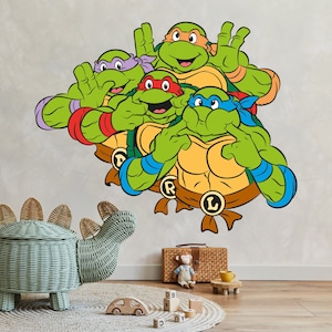 May include: Four Teenage Mutant Ninja Turtles characters in a green, red, purple, and blue colour scheme. The characters are wearing masks and bandanas. The characters are in a fighting pose with their hands raised. The characters are on a white background.