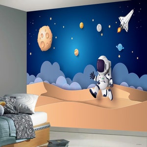 Mural de pared espacial: astronauta de dibujos animados saltando sobre un planeta Mural de pared completo Arte infantil