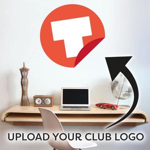 May include: A red and white logo sticker with a peeling corner on a white wall. A black arrow points to a desk with a laptop, radio, and a red toy car. The text "UPLOAD YOUR CLUB LOGO" is at the bottom.