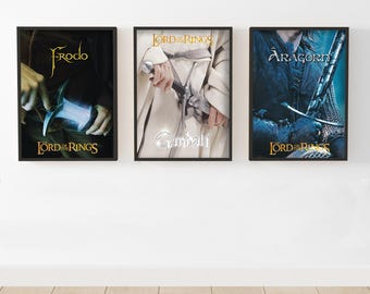 May include: Three framed movie posters from "The Lord of the Rings" trilogy. The posters feature Frodo, Gandalf, and Aragorn. Each poster has a black frame and the movie title at the top and bottom.