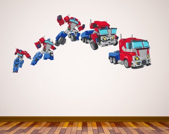May include: A set of five wall decals featuring a red and blue robot transforming into a red semi-truck. The decals are arranged in a curved line, with the robot in various stages of transformation.