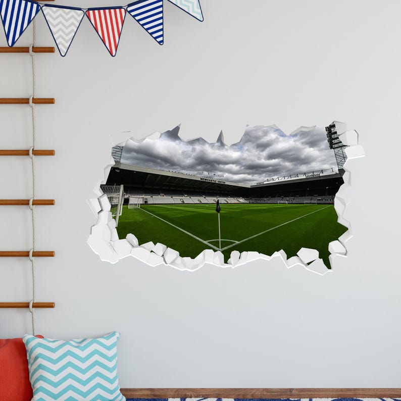 K&ouml;nnte beinhalten: Ein Wandaufkleber mit einem realistischen 3D-Effekt eines Fu&szlig;ballstadions mit einem gr&uuml;nen Rasen und einem bew&ouml;lkten Himmel. Der Aufkleber scheint aus der Wand gerissen zu sein und erzeugt so einen dramatischen Effekt.
