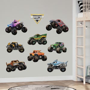 May include: A set of eight Monster Jam monster truck wall decals. The decals feature different monster trucks with various colors and designs, including a purple unicorn truck, a green and black truck, a red and black truck, a blue and white shark truck, and an orange truck. The decals are perfect for adding a fun and exciting touch to any child's room.