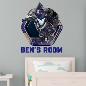 May include: Wall decal featuring a futuristic warrior in a hexagonal frame with blue and gold accents. The text "BEN'S ROOM" is displayed in blue below the image. The decal is likely for a child's bedroom.