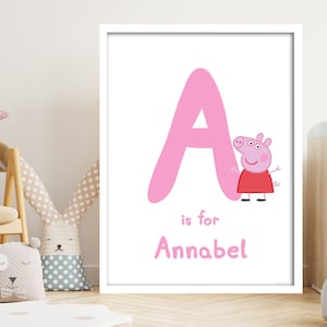 Könnte beinhalten: Ein rosa Buchstabe A mit einer Cartoon-Schweinefigur daneben. Der Text "is for Annabel" steht unter dem Buchstaben.